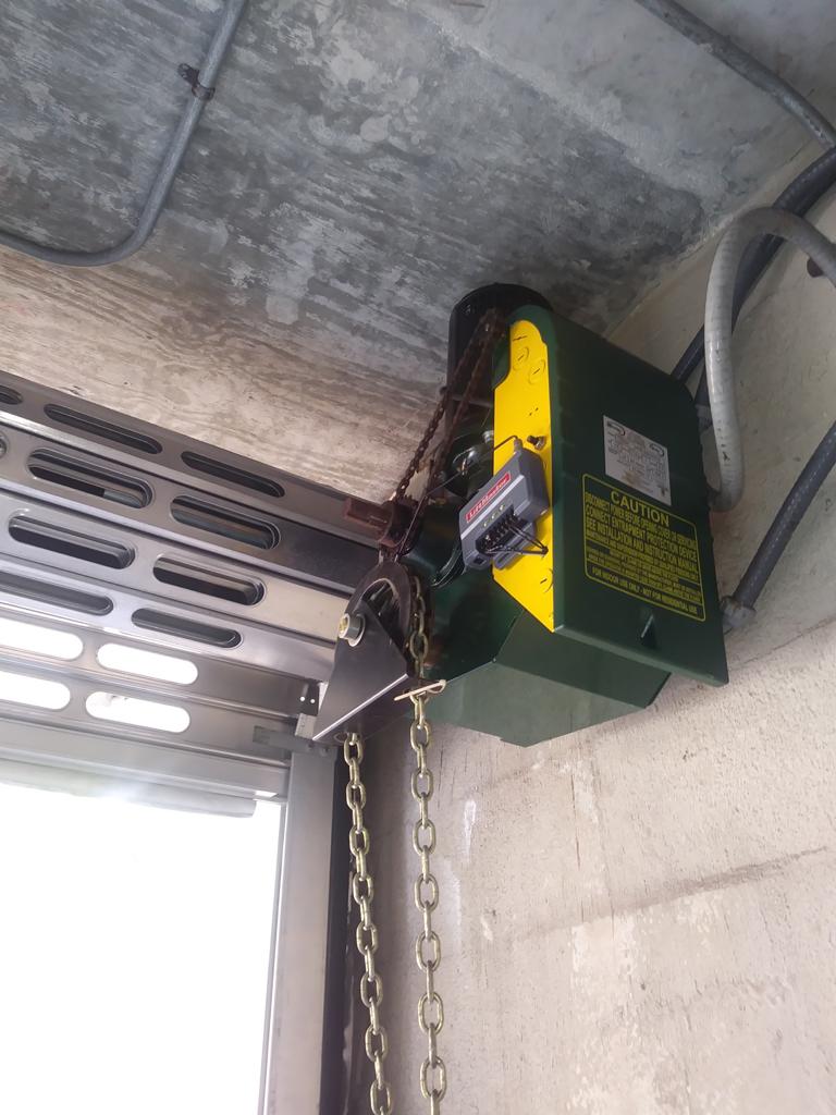 Technician fitting a garage door track