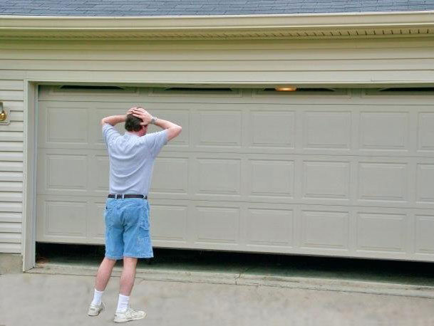 Technician carrying out a garage door repair in Miami
