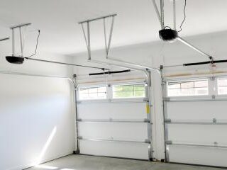 Electric garage door opener mounted above a garage