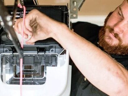 Garage door cables and a broken spring being replaced