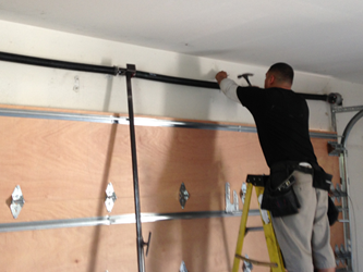 Garage door torsion spring above a closed door